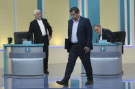 In this picture made available by Young Journalists Club, YJC, presidential candidates for June 18, elections Saeed Jalili, left, Abdolnasser Hemmati, center, and Alireza Zakani, conclude a part of the final debate of the candidates at a state-run TV studio in Tehran, Iran, Saturday, June 12, 2021. Iran's seven presidential candidates offered starkly different views Saturday in the country's final debate, with hard-liners describing those seeking ties with the West as "infiltrators" and the race's sole moderate warning a hard-line government would only bring more sanctions for the Islamic Republic. (Morteza Fakhri Nezhad/ Young Journalists Club, YJC via AP)