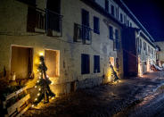 An illuminated Christmas tree leans against the windows of a damaged house in Mayschoss in the Ahrtal valley, southern Germany, Tuesday, Dec.14, 2021. Amid the mud and debris still clogging the streets from last summer's devastating floods, residents of the Ahr Valley in western Germany are trying to spark some festive cheer with Christmas trees. (Photo/Michael Probst)