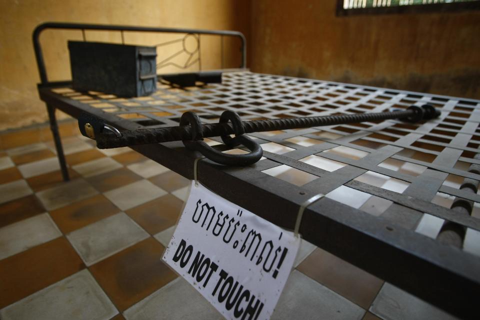 In this photo taken Thursday, Feb. 20, 2014, a metal cot is displayed in a room used as a torture chamber at the Tuol Sleng Genocide Museum, formerly the most notorious Khmer Rouge prison, in Phnom Penh, Cambodia. The office of Cambodia's most celebrated filmmaker is filled with books on the Khmer Rouge - on his desk, on the walls, in the filing cabinets and in every corner of Rithy Panh's dimly lit office are memories of his country's national tragedy. In his latest movie, the 51-year-old filmmaker focuses for the first time on his personal story of loss and tormented survival. "The Missing Picture" won an award at last year's Cannes Film Festival and is up for Best Foreign Language Film at the Oscars this weekend, marking the first time a Cambodian film has been nominated for an Academy Award. (AP Photo/Heng Sinith)