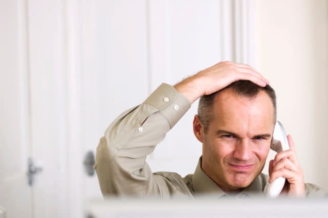 B0FGXA Businessman on phone sat at desk