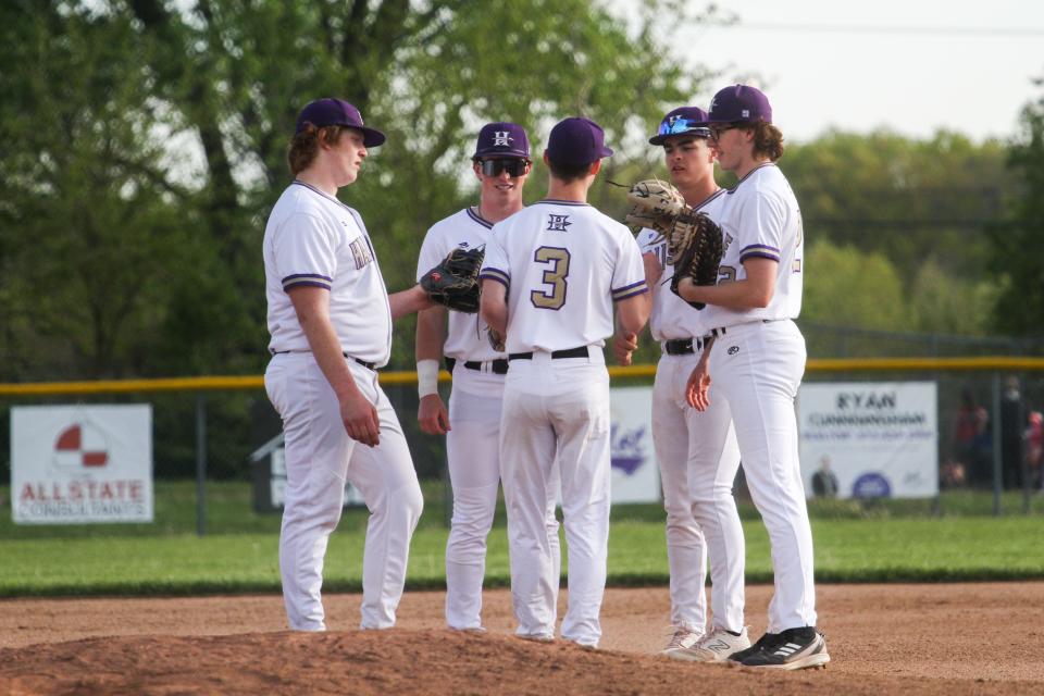 Hallsville players chat near the pitcher’s mound during a baseball game between Tolton and Hallsville on Friday, April 19, 2024, in Hallsville.