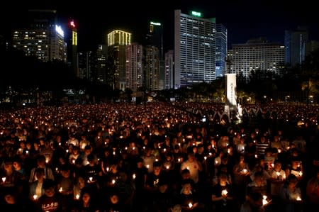 FILE PHOTO: People take park in a candlelight vigil to mark the 27th anniversary of the crackdown of pro-democracy movement at Beijing's Tiananmen Square, in Hong Kong