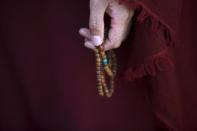 A Tibetan nun holds prayer beads during a function organised by the Tibetan Refugee Community in Nepal commemorating the 25th anniversary of the Nobel Peace Prize conferment to exiled Tibetan spiritual leader Dalai Lama and the 66th International Human Rights Day in Kathmandu in this December 10, 2014 file photo. REUTERS/Navesh Chitrakar/Files