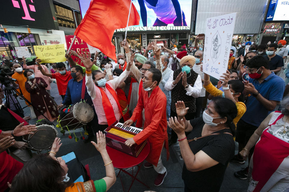 People gather in Times Square on Wednesday, Aug. 5, 2020, in New York after the groundbreaking ceremony of a temple being built on disputed ground in India. Indian Prime Minister Narendra Modi participated in the groundbreaking for the Hindu temple Wednesday in the Indian city of Ayodhya. (AP Photo/Frank Franklin II)