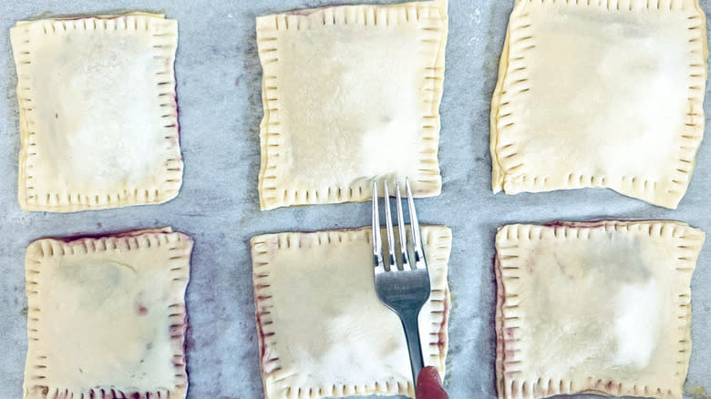 fork crimping edges of pastry