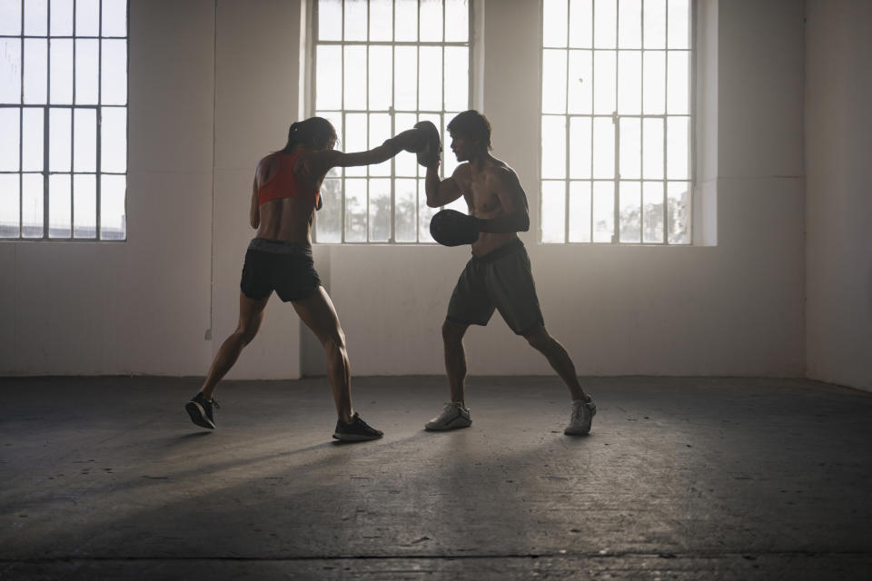 a woman and a man boxing