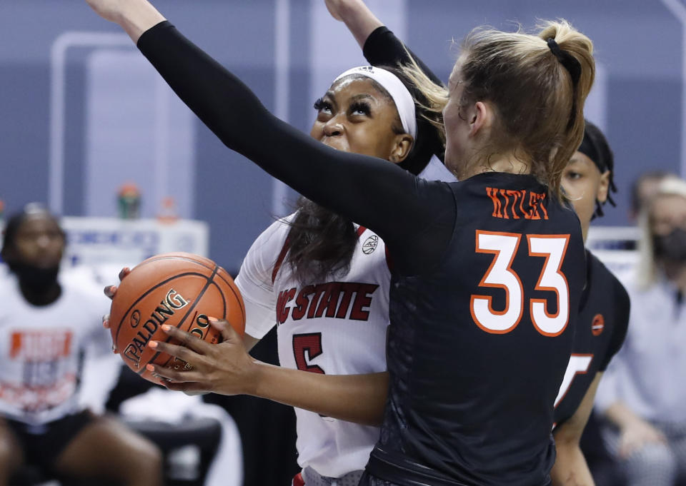 North Carolina State's Jada Boyd (5) looks to shoot as Virginia Tech's Elizabeth Kitley (33) defends during the first half of an NCAA college basketball game in the Atlantic Coast Conference women's tournament in Greensboro, N.C., Friday, March 5, 2021. (Ethan Hyman/The News & Observer via AP)