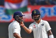 Cricket - India v New Zealand - Third Test cricket match - Holkar Cricket Stadium, Indore, India - 09/10/2016. India's Virat Kohli takes off Ajinkya Rahane's helmet. REUTERS/Danish Siddiqui