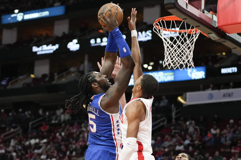 Philadelphia 76ers center Montrezl Harrell, left, shoots as Houston Rockets forward Jabari Smith Jr., right, defends during the first half of an NBA basketball game, Monday, Dec. 5, 2022, in Houston. (AP Photo/Eric Christian Smith)