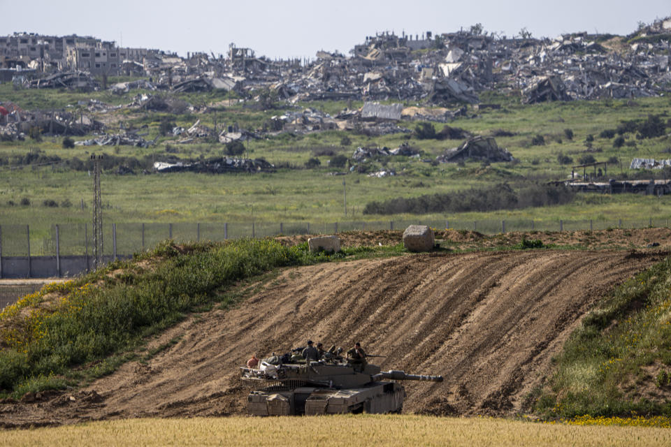 Israeli soldiers rest on top of their tank on the border with the Gaza Strip, in southern Israel, Tuesday, March 26, 2024. (AP Photo/Ariel Schalit)