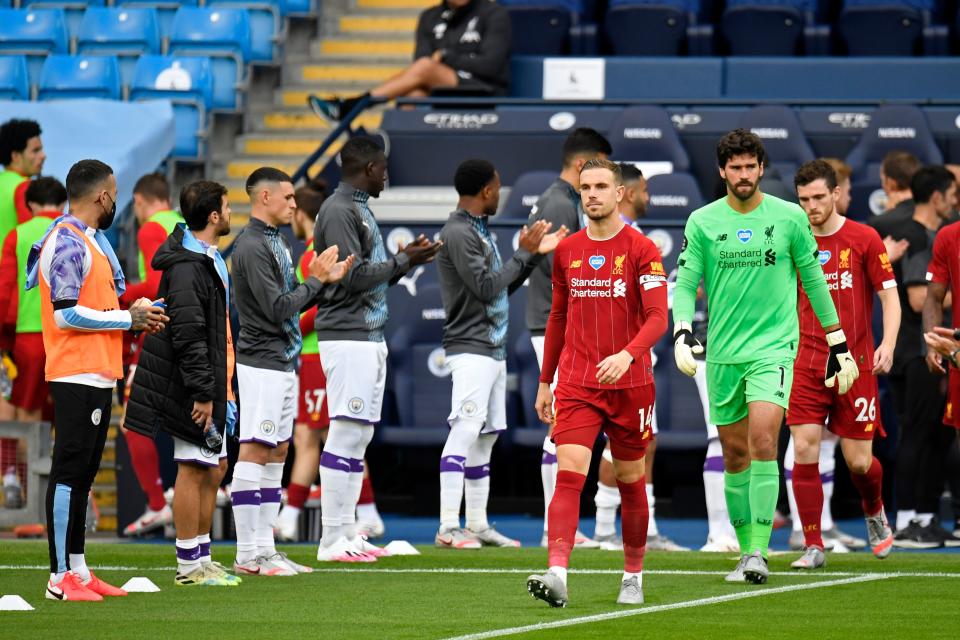 Manchester City players form a guard of honour for the Liverpool players as they make their way onto the pitch after capturing the league title last week, ahead of the English Premier League football match between Manchester City and Liverpool at the Etihad Stadium in Manchester, north west England, on July 2, 2020. (Photo by PETER POWELL / POOL / AFP) / RESTRICTED TO EDITORIAL USE. No use with unauthorized audio, video, data, fixture lists, club/league logos or 'live' services. Online in-match use limited to 120 images. An additional 40 images may be used in extra time. No video emulation. Social media in-match use limited to 120 images. An additional 40 images may be used in extra time. No use in betting publications, games or single club/league/player publications. /  (Photo by PETER POWELL/POOL/AFP via Getty Images)