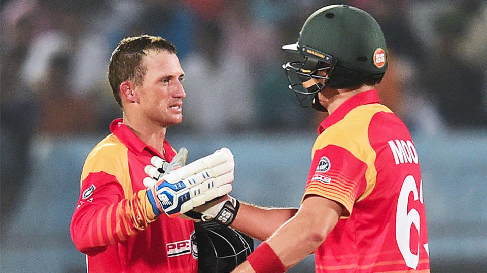 Zimbabwe's cricketer Sean Williams (L) celebrates his century (100 runs) with teammate Peter Moor (R) during the third one day international (ODI) cricket match between Bangladesh and Zimbabwe at the Zahur Ahmed Chowdhury Stadium in Chittagong on October 26, 2018. (Photo by MUNIR UZ ZAMAN / AFP) (Photo credit should read MUNIR UZ ZAMAN/AFP/Getty Images)