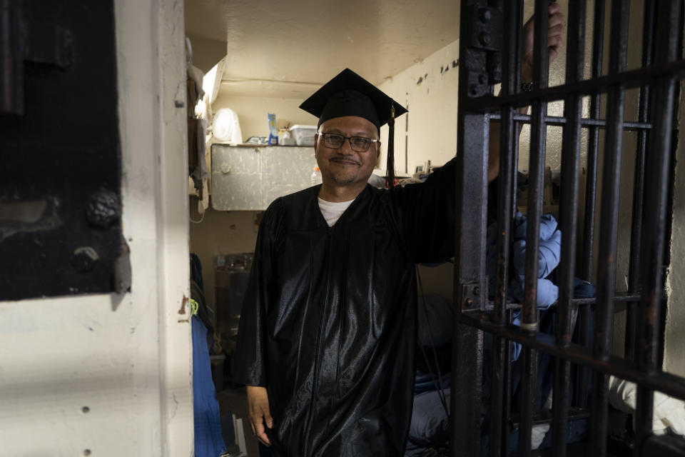 Lambert Pabriaga, who earned a bachelor's degree in communications through the Transforming Outcomes Project at Sacramento State (TOPSS), stands for a portrait in his cell after a graduation ceremony at Folsom State Prison in Folsom, Calif., Thursday, May 25, 2023. (AP Photo/Jae C. Hong)