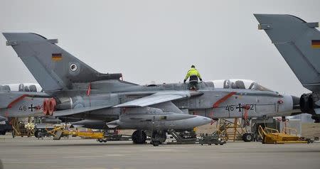 A technician works on a German Tornado jet at the air base in Incirlik, Turkey, January 21, 2016. REUTERS/Tobias Schwarz