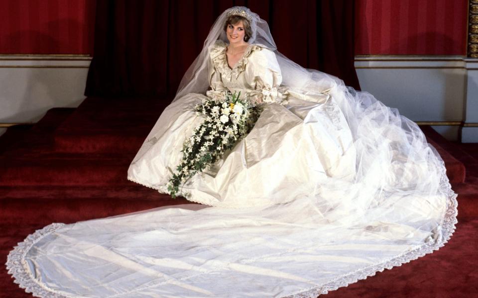 Princess Diana on her wedding day; she wore the Spencer tiara and a gown with a 25ft train, the longest ever worn by a royal bride - PA