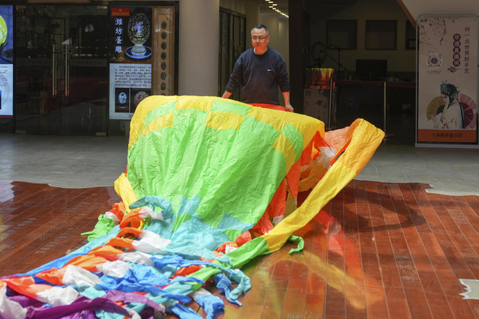 Kitemaker Liu Zhijiang prepares a kite at his workshop in Weifang, Shandong Province of China, Friday, April 19, 2024. (AP Photo/Tatan Syuflana)