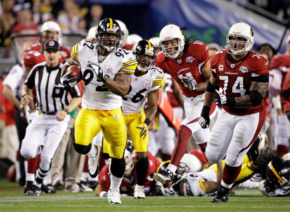 Pittsburgh Steelers linebacker James Harrison returns the ball 100 yards for a touchdown after an interception on the final play of the first half against the Arizona Cardinals in Super Bowl 43 in Tampa, Fla.