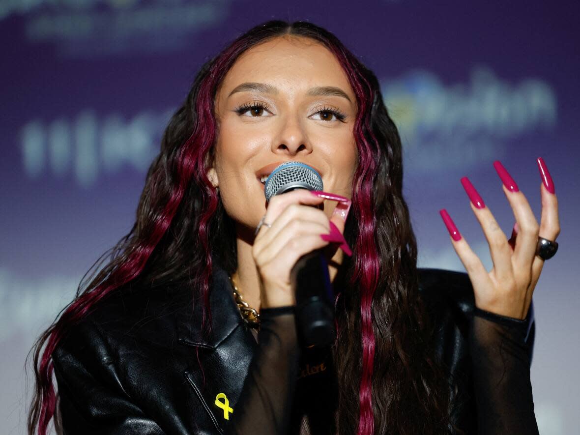 Eden Golan, Israel's representative at the Eurovision Song Contest, reacts during a media conference following the official unveiling of Israel's song submission, in Tel Aviv earlier this month. The country was forced to change its song following a decision by contest organizers that the original was too political. (Carlos Garcia Rawlins/Reuters - image credit)