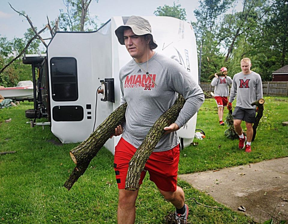 Miami football player Bennett Clark and teammates help with tornado cleanup in Beavercreek. (WHIO File)