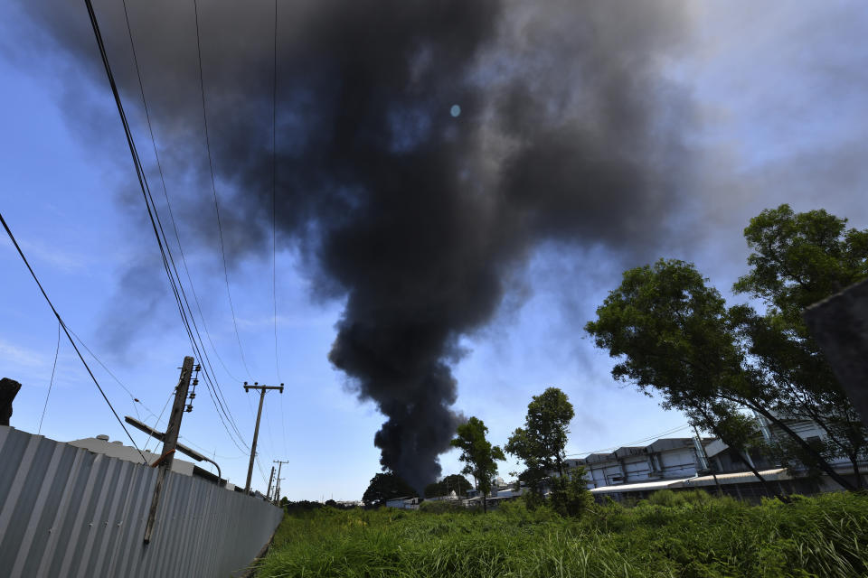 Smoke rises into the air from a factory in Samut Prakan province, Thailand, Monday, July 5, 2021. A massive explosion at the factory on the outskirts of Bangkok early Monday shook an airport terminal serving Thailand's capital and prompted the evacuation of residents from the area. (AP Photo)