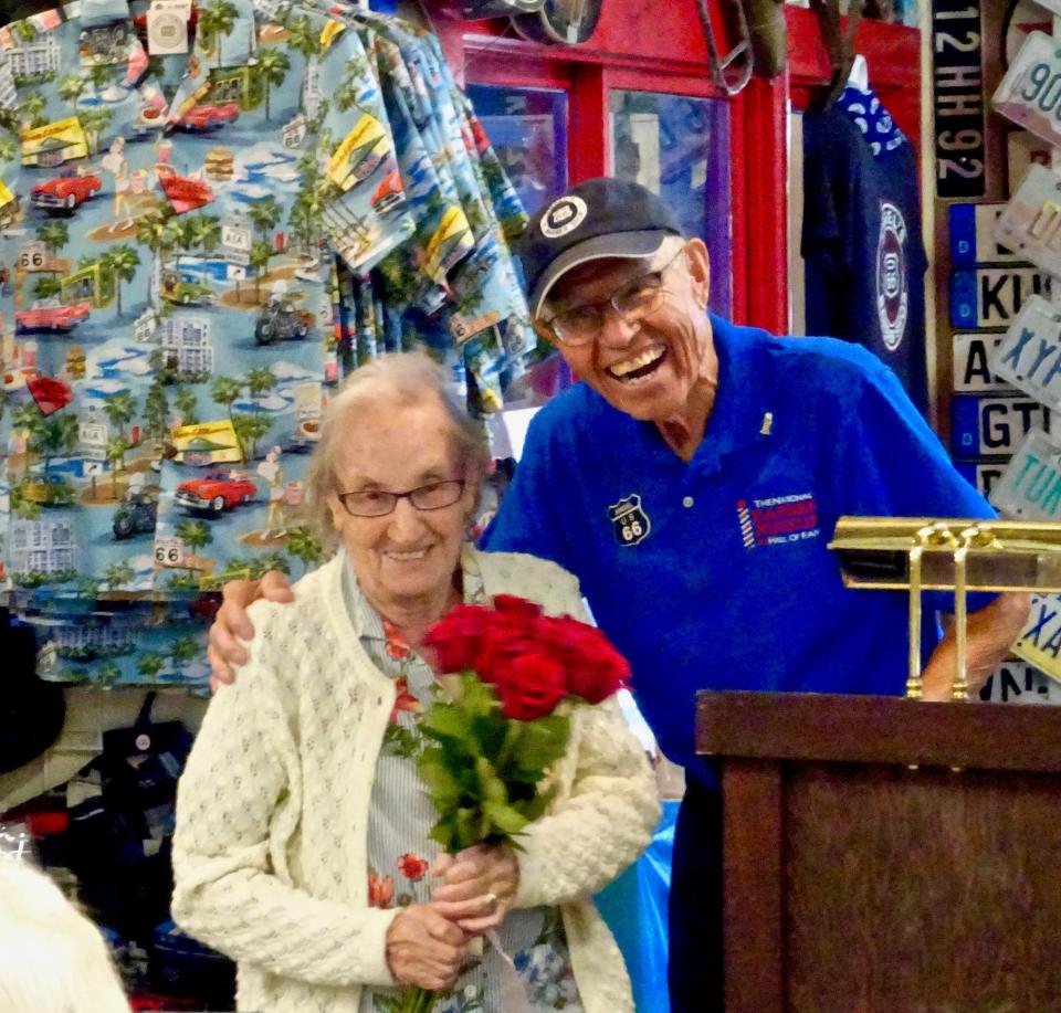 Angel Delgadillo and his wife Vilma share a moment at Angel's retirement party on July 7, 2022. Delgadillo is a longtime barber who started the movement to preserve historic Route 66.