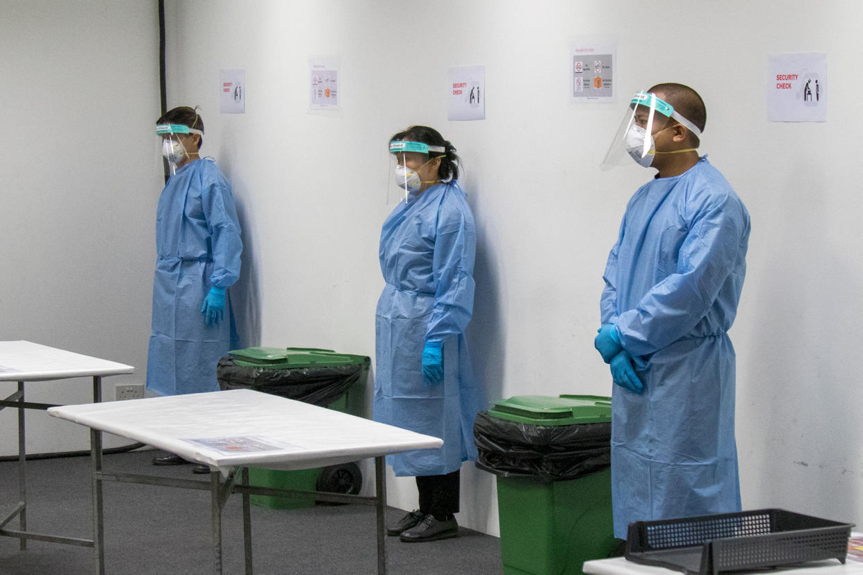 Staff at the Changi Exhibition Centre isolation facility for COVID-19 patients seen fully outfitted in personal protective equipment, during a media tour on 24 April 2020. (PHOTO: Dhany Osman / Yahoo News Singapore)