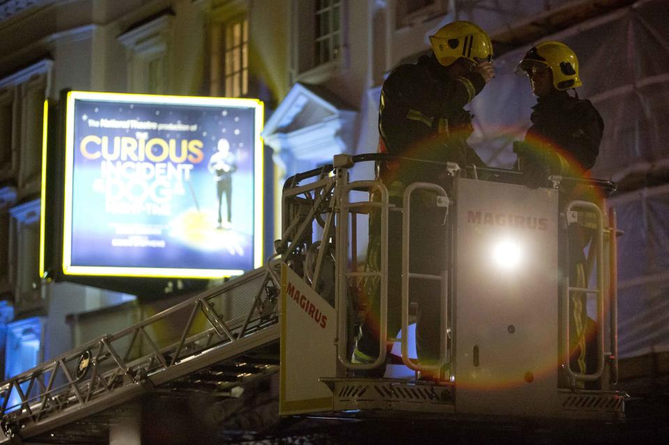 Emergency services use a cherry picker to look at the roof of the Apollo Theatre on Shaftesbury Avenue after part of the ceiling collapsed in central London
