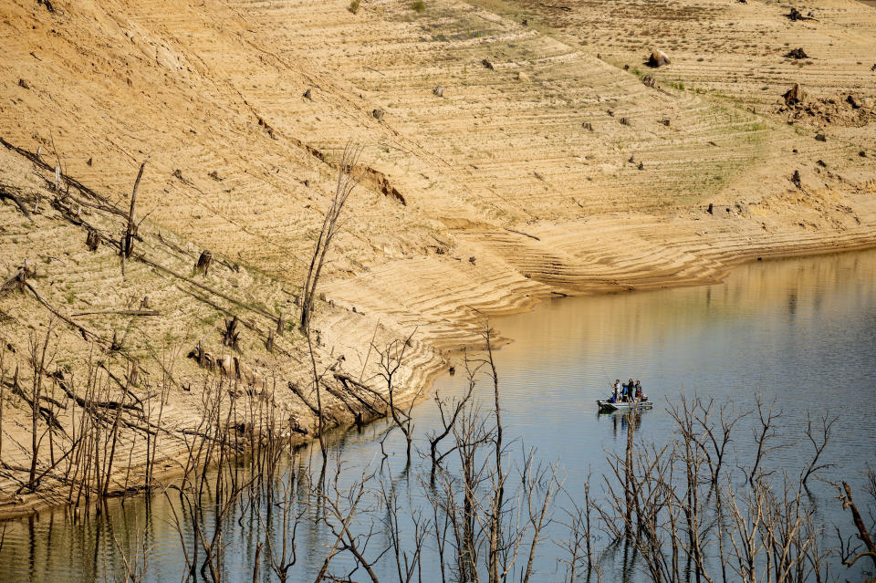 Anglers fish below a dry hillside at Lake Oroville on Sunday, May 23, 2021, in Oroville, Calif. At the time of this photo, the reservoir was at 39 percent of capacity and 46 percent of its historical average. California officials say the drought gripping the U.S. West is so severe it could cause one of the state's most important reservoirs to reach historic lows by late August, closing most boat ramps and shutting down a hydroelectric power plant during the peak demand of the hottest part of the summer. (AP Photo/Noah Berger)