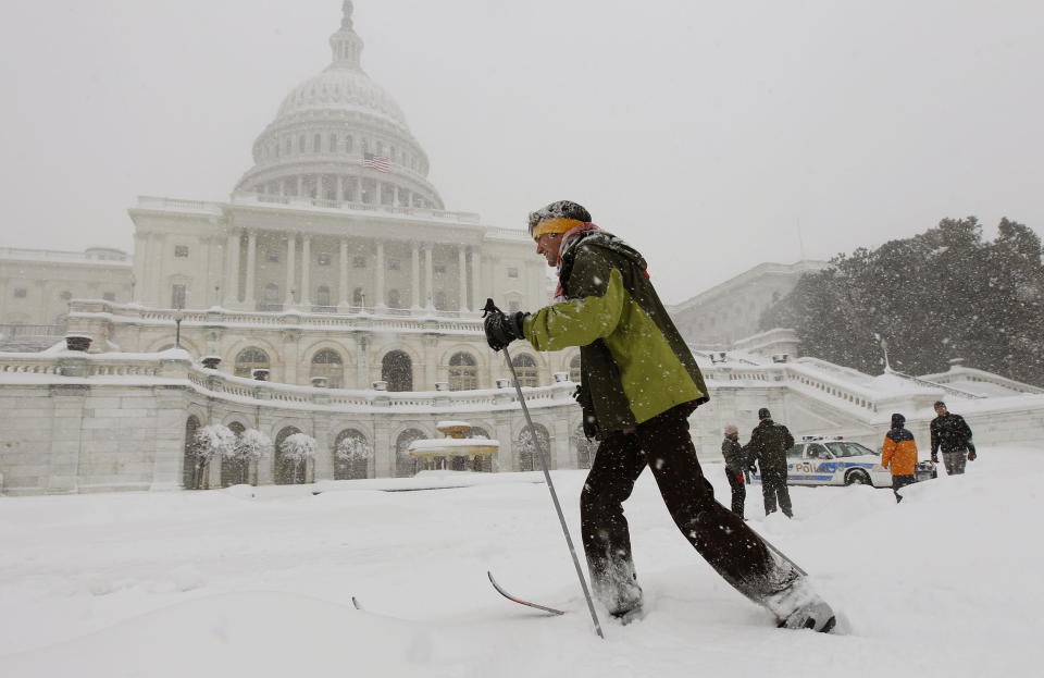 FILE - Travis Grout uses his cross country snow skis to get around the West Front of the Capitol in Washington, Feb. 6, 2010. Federal forecasters are predicting on Thursday, Oct. 19, 2023, less snow in general for the United States winter, but they said big snow events are possible like Washington’s paralyzing Snowmageddon storm that dumped more than 2 feet on the capital region during an El Nino. (AP Photo/Alex Brandon, File)