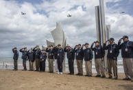 FILE - In this Monday, June, 3, 2019, file photo, World War II veterans from the United States salute as they pose in front of Les Braves monument at Omaha Beach in Saint-Laurent-sur-Mer, Normandy, France. In sharp contrast to the 75th anniversary of D-Day, this year's 76th will be one of the loneliest remembrances ever, as the coronavirus pandemic is keeping nearly everyone from traveling. (AP Photo/Rafael Yaghobzadeh, File)