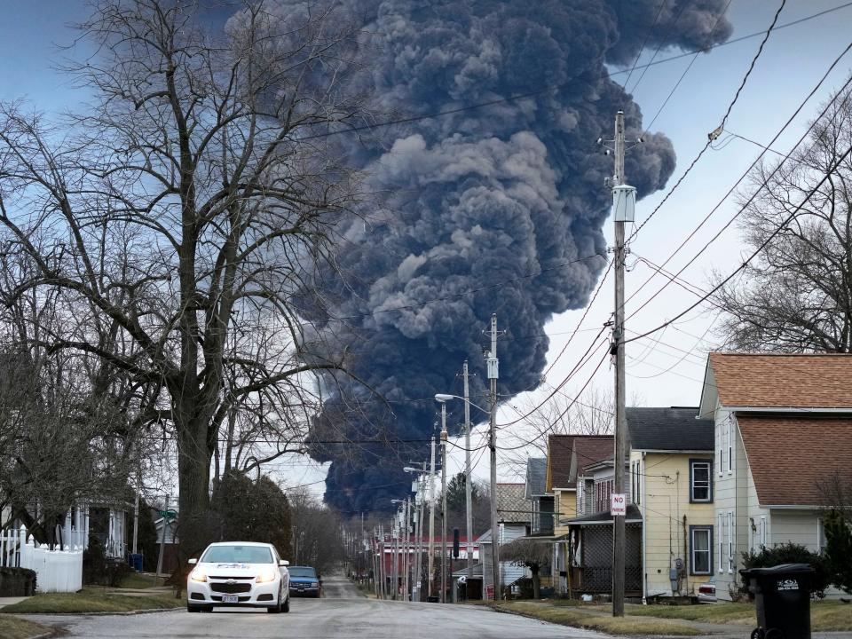 A dark plume of smoke rises from a train derailment in East Palestine, Ohio, that leaked toxic chemicals.