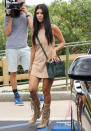 <p>The mother-of-three stepped out in L.A. wearing head-to-toe suede in a tan-hued suede minidress and matching fringe lace-up boots. She topped off the outfit with a forest green Céline crossbody bag and a gold cuff.</p>