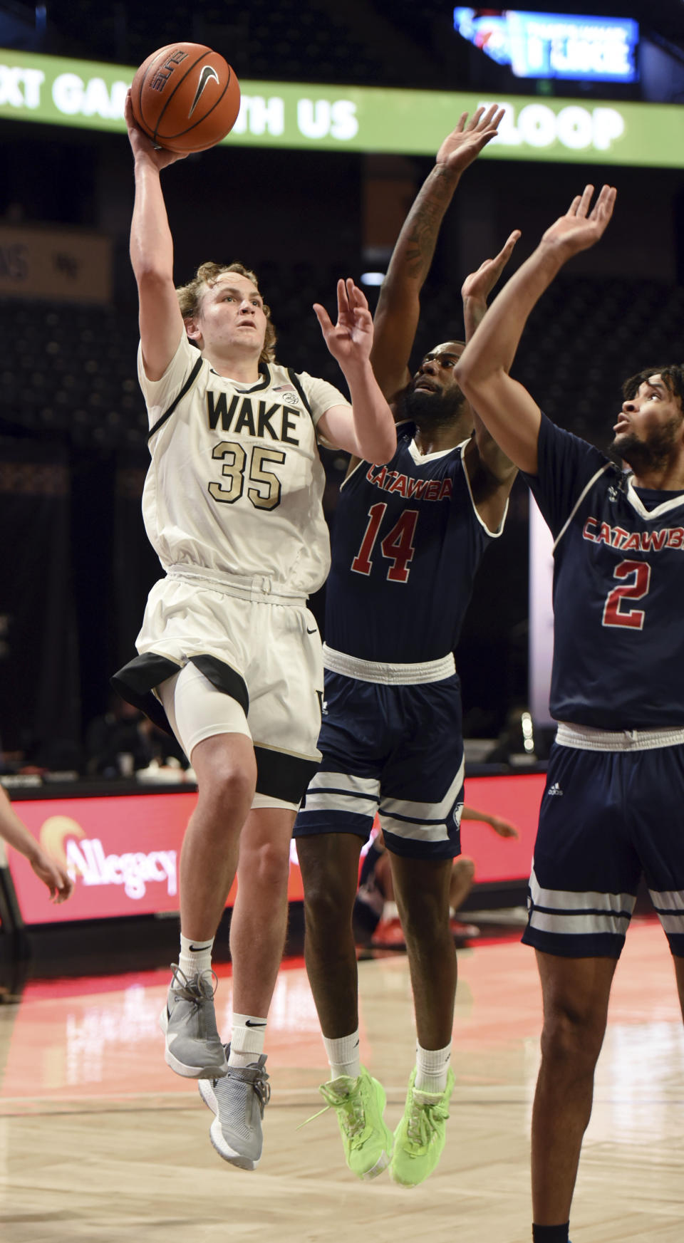 Wake Forest's Carter Whitt (35) shoots over Catawba's Taqwain Drummond (14) and Todd Burt (2) during an NCAA college basketball game, Thursday, Dec. 31, 2020, at Joel Coliseum in Winston-Salem, N.C. (Walt Unks//The Winston-Salem Journal via AP)