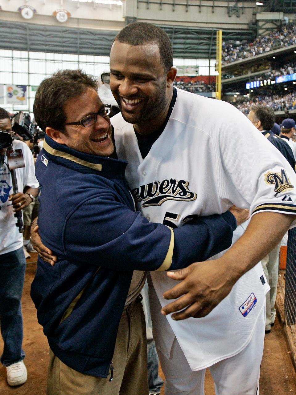 Milwaukee Brewers starting pitcher CC Sabathia (right) is congratulated by owner Mark Attanasio after the Brewers beat the Chicago Cubs, 3-1, on Sept. 28, 2008, to clinch a wild-card berth.