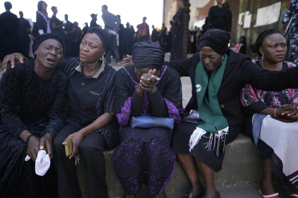 Women react under the bridge during a march in solidarity with the victims of the Christmas Eve attack, in Jos, Nigeria, Saturday, Jan. 6, 2024. Nigerian officials and survivors say at least 140 people were killed by gunmen who attacked remote villages in north-central Nigeria's Plateau state in the latest of such mass killings. (AP Photo/Sunday Alamba)