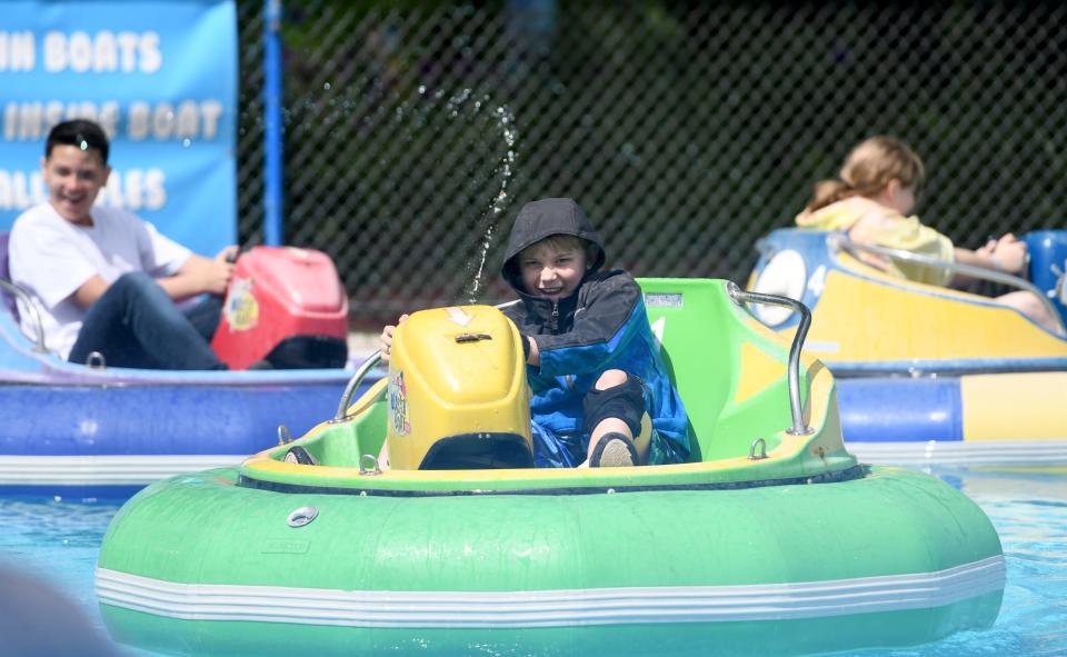 Kam Beatty keeps his eye on the target while riding bumper boats at Sluggers & Putters Amusement Park in Canal Fulton when Massillon City School fifth grade students visited the park.