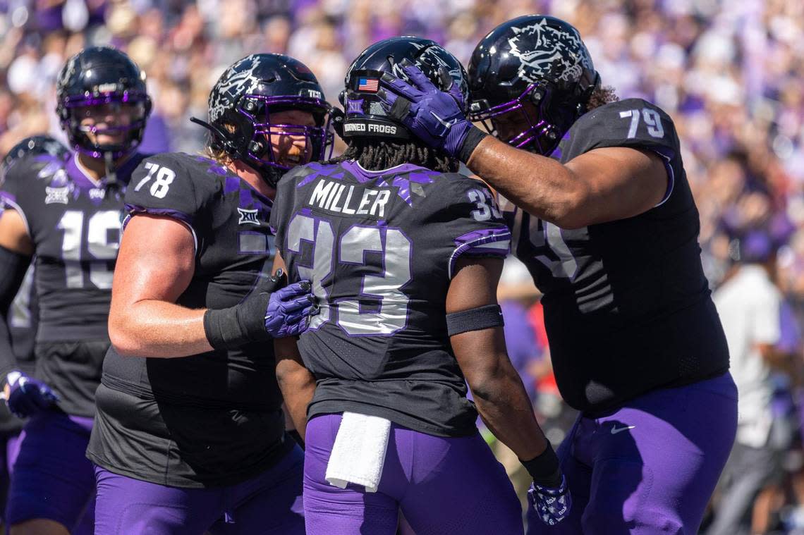 TCU guard Wes Harris, running back Kendre Miller and center Steve Avila celebrate after Miller scores a touchdown during their game against Oklahoma at Amon G. Carter Stadium on Oct. 1.