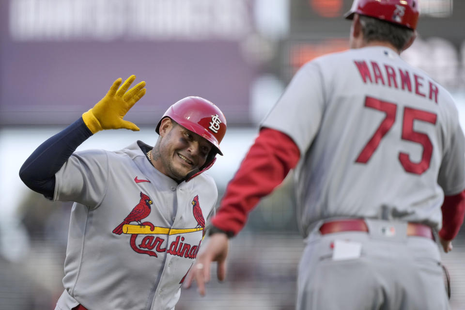 St. Louis Cardinals' Yadier Molina, left, is congratulated by third base coach Ron Warner (75) as he rounds the bases after hitting a solo home run against the San Francisco Giants during the third inning of a baseball game Thursday, May 5, 2022, in San Francisco. (AP Photo/Tony Avelar)