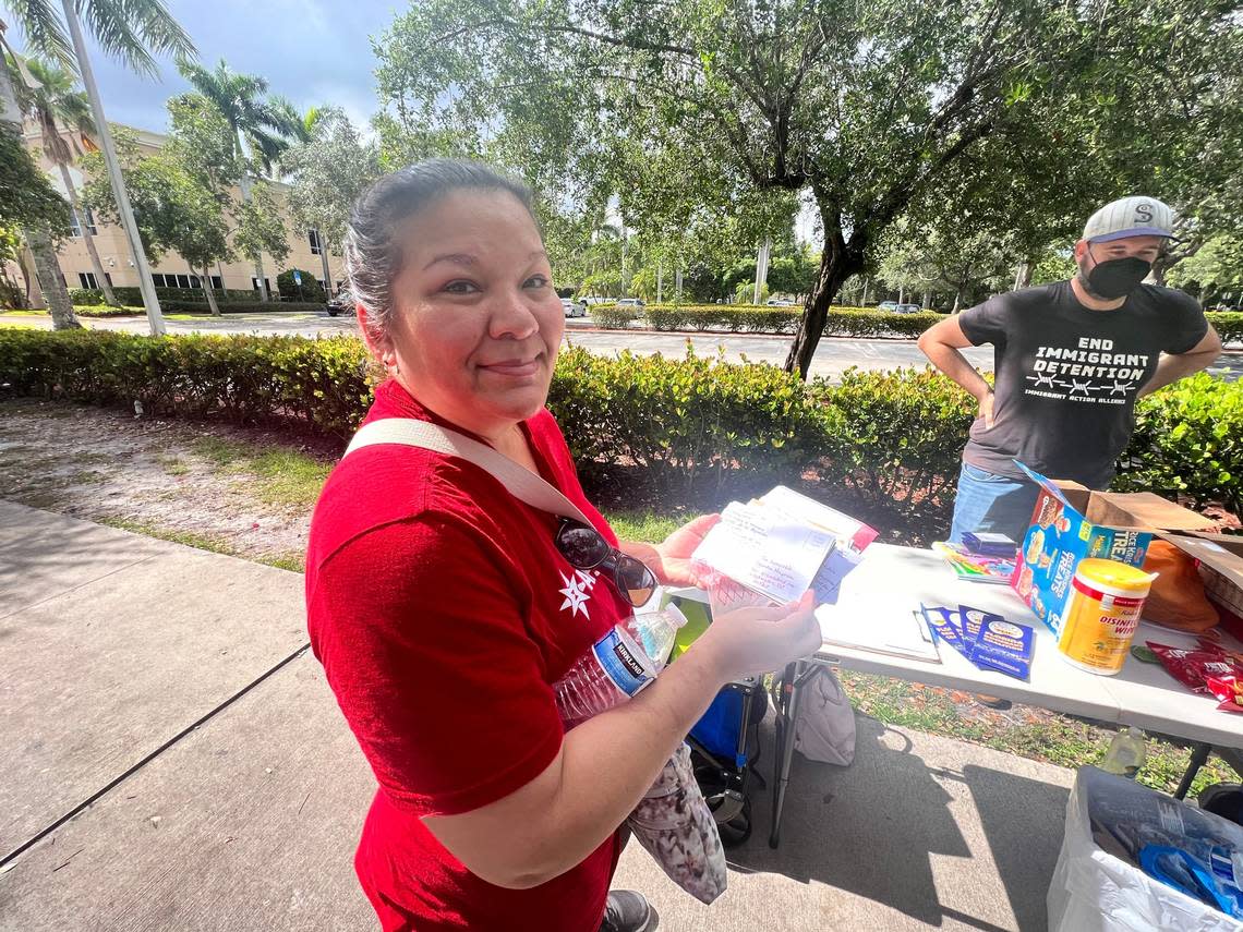 Berta Wilson, of the American Friends Service Committee and the Miramar Circle of Protection, holds up some of the postcards the postcard writing campaign has collected