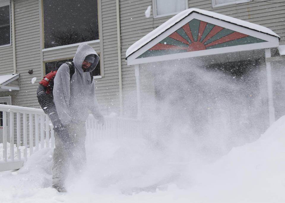 <p>Julio Carrera-Veliz uses a blower to clear walkways of snow in Chester, N.J., Wednesday, March 21, 2018. A spring nor’easter targeted the Northeast on Wednesday with strong winds and a foot or more of snow expected in some parts of the region. (Photo: Seth Wenig/AP) </p>