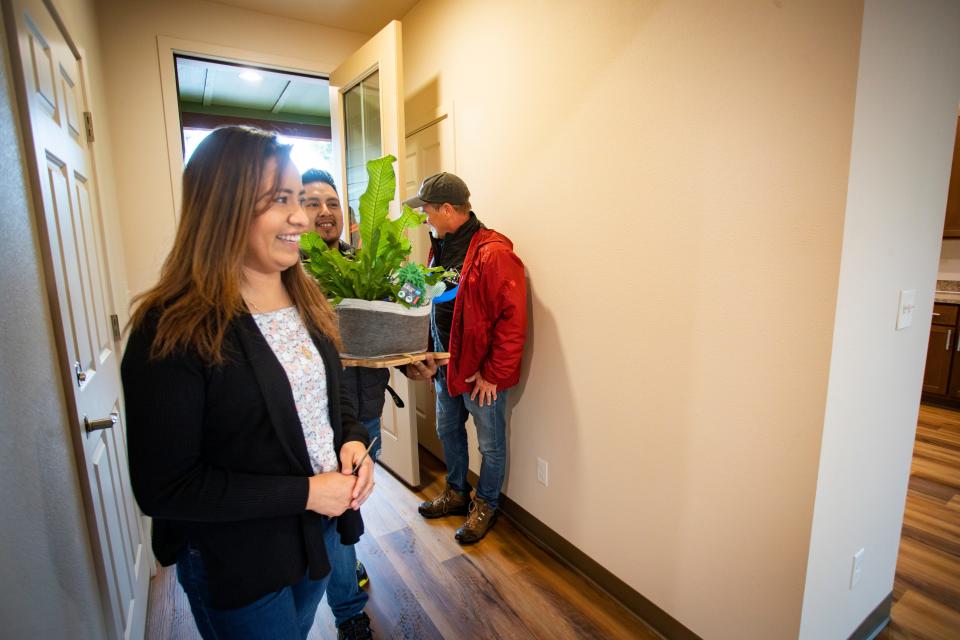 Margarita Vasquez Cruz, left, and Heron Maya Ruiz walk through their new home built by students in Eugene School District 4J’s Future Build career technical education program.