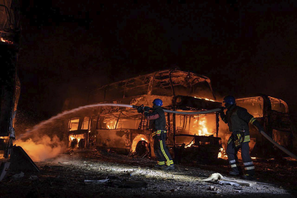 In this photo provided by the Ukrainian Emergency Situations Ministry, firefighters put out fire caused by fragments of a Russian rocket after it was shot down by air defense system during the night Russian rocket attack in Kyiv, Ukraine, early hours Tuesday, May 16, 2023. (Ukrainian Emergency Situations Ministry via AP)