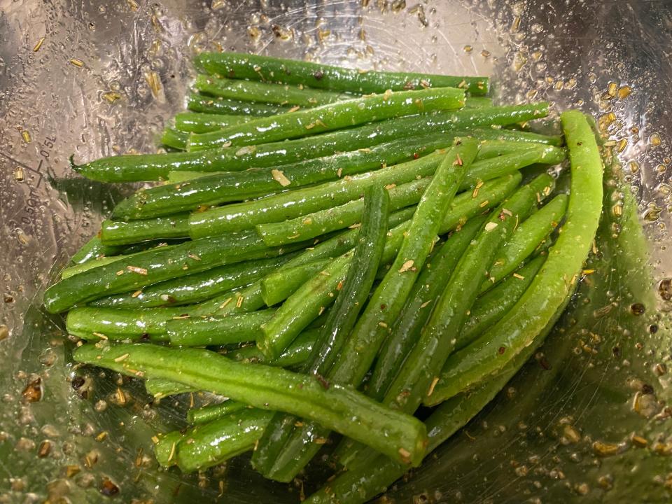 a bowl of cooked and seasoned green beans