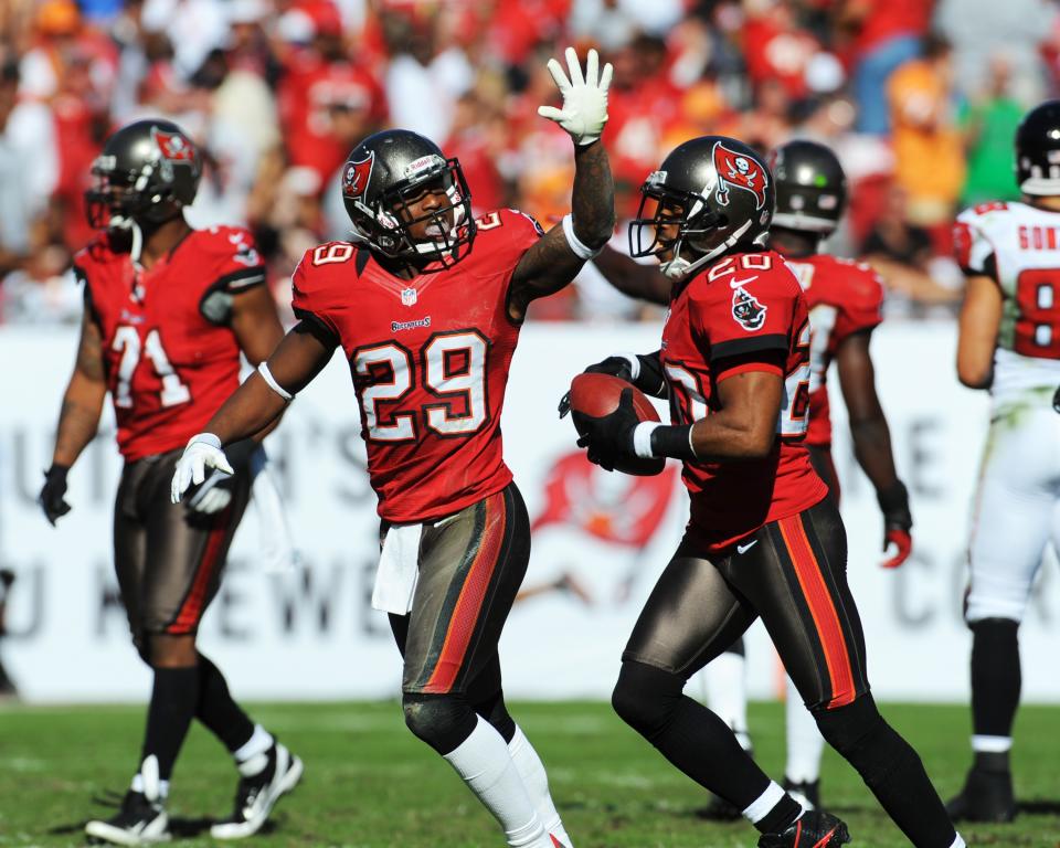 TAMPA, FL - NOVEMBER 25: Defensive back Ronde Barber #20 of the Tampa Bay Buccaneers celebrates a second-quarter interception with cornerback Leonard Johnson #29 against the Atlanta Falcons November 25, 2012 at Raymond James Stadium in Tampa, Florida. (Photo by Al Messerschmidt/Getty Images)