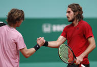 Stefanos Tsitsipas, right, of Greece shake hands with Andrey Rublev of Russia after winning the Monte Carlo Tennis Masters tournament finals in Monaco, Sunday, April 18, 2021. (AP Photo/Jean-Francois Badias)