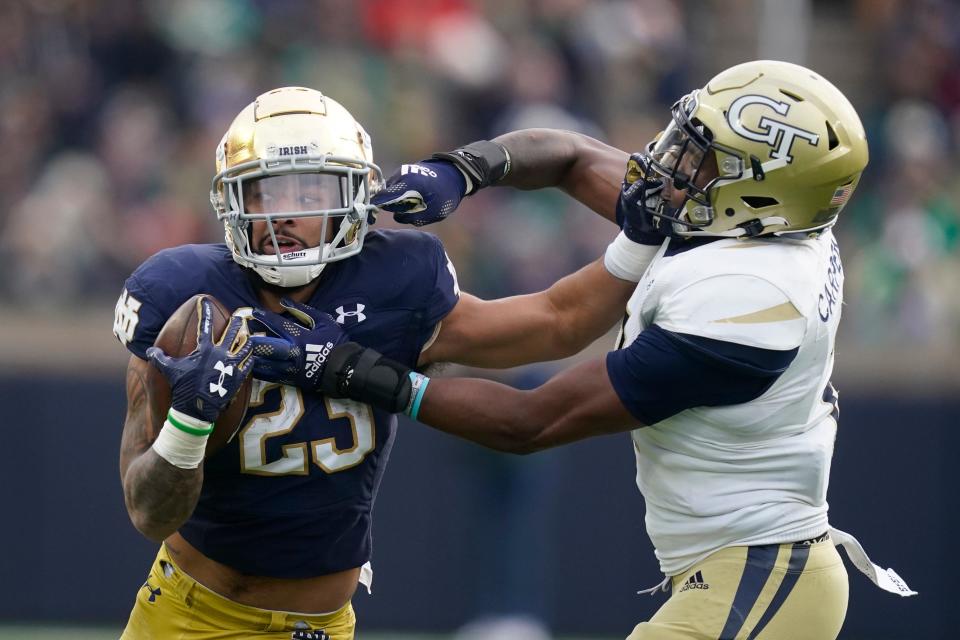 Notre Dame&#39;s Kyren Williams is tackled by Georgia Tech&#39;s Tariq Carpenter during the game on Nov. 20 in South Bend, Ind.