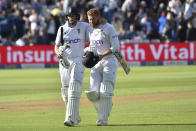 England's Joe Root, left, walks off the field with batting partner Jonny Bairstow at the end of play on the fourth day of the fifth cricket test match between England and India at Edgbaston in Birmingham, England, Monday, July 4, 2022. (AP Photo/Rui Vieira)