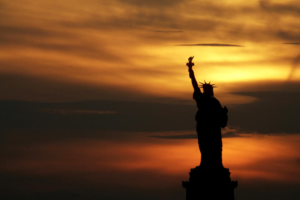 FILE - In this July 3, 2007, file photo, the Statue of Liberty stands at sunset in New York. The Statue of Liberty is at the center of a national debate on immigration after a top Trump administration official offered the president’s own interpretation of the famous inscription that has welcomed immigrants to the United States for more than a century. (AP Photo/Seth Wenig, File)