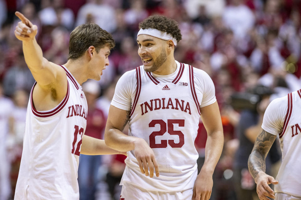 Indiana forwards Miller Kopp (12) and Race Thompson (25) react after defeating Michigan in overtime of an NCAA college basketball game, Sunday, March 5, 2023, in Bloomington, Ind. (AP Photo/Doug McSchooler)