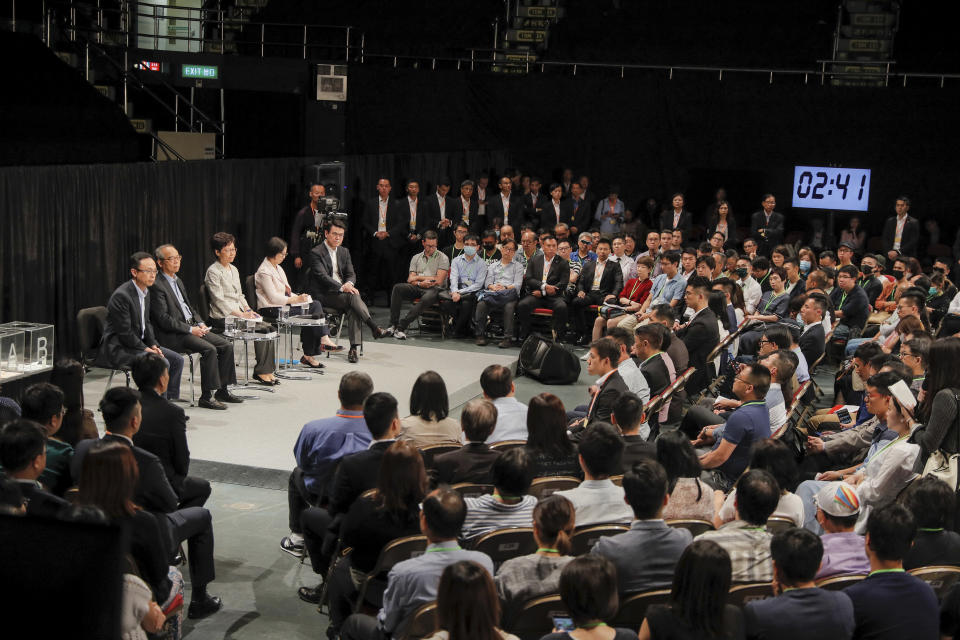 Hong Kong Chief Executive Carrie Lam, center on the stage, attends a community dialogue at the Queen Elizabeth Stadium in Hong Kong, Thursday, Sept. 26, 2019. Scores of protesters chanted slogans outside the venue as Lam began the town hall session Thursday aimed at cooling down months of demonstrations for greater democracy in the semi-autonomous Chinese territory. (AP Photo/Kin Cheung)